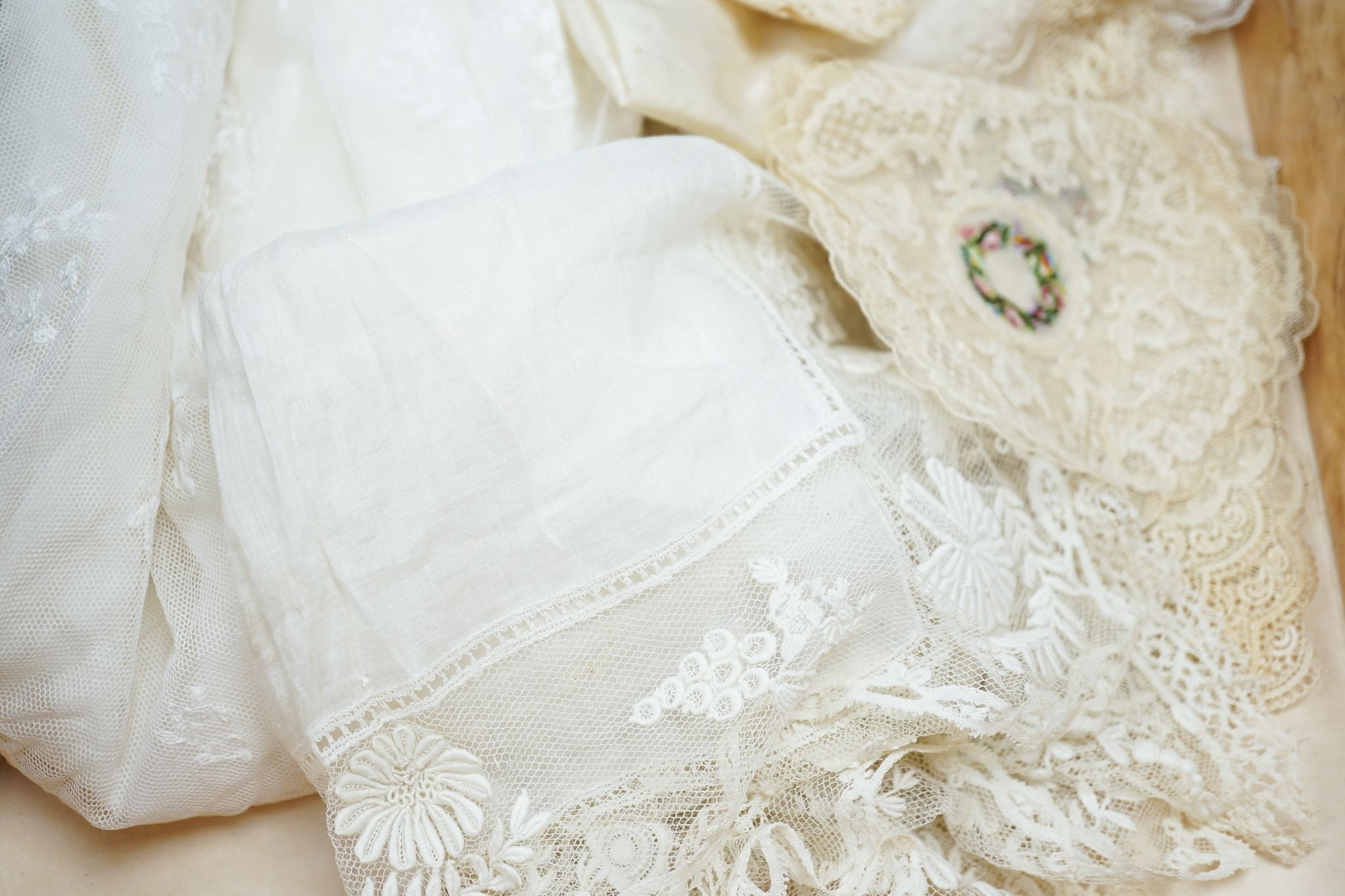 Two early 19th century, finely white worked lace hankies, various sets of lace mats and a lace baby dress, Hankies 40 cms x 40 cms.